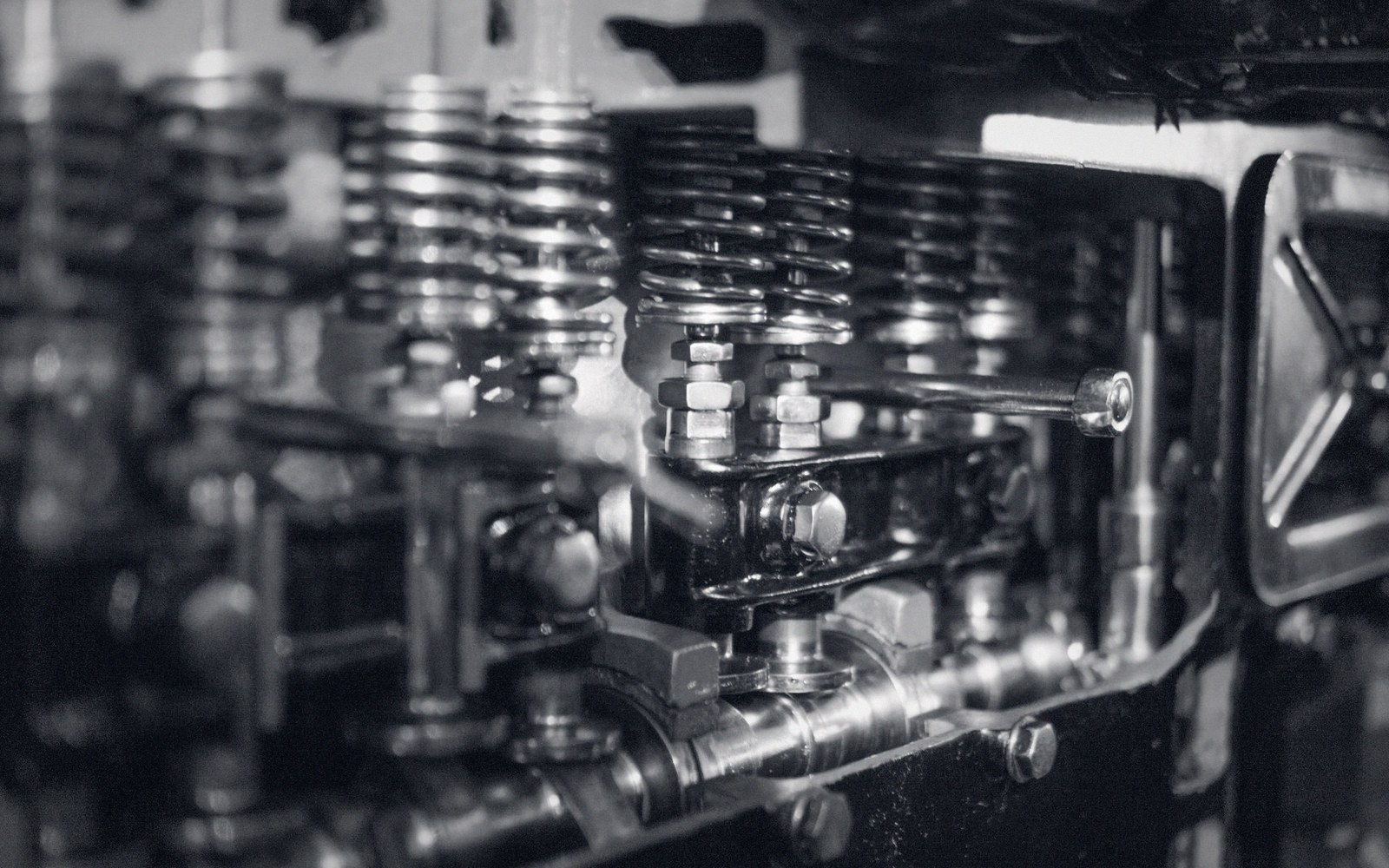 Close-up of an engine's valve springs, rocker arms and bolts on the cylinder head